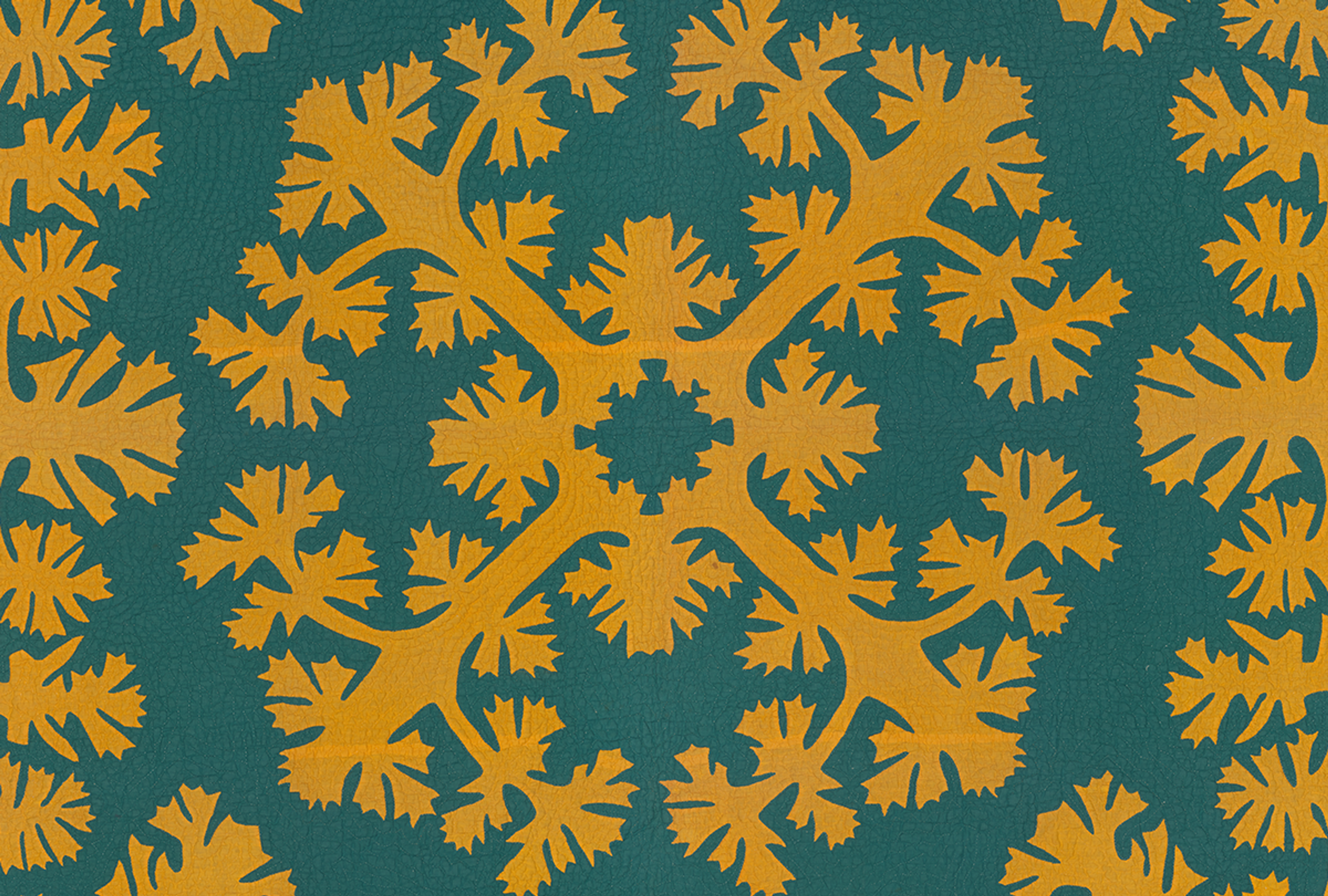 A yellow and blue Hawaiian quilt featuring a lei mamo pattern.
